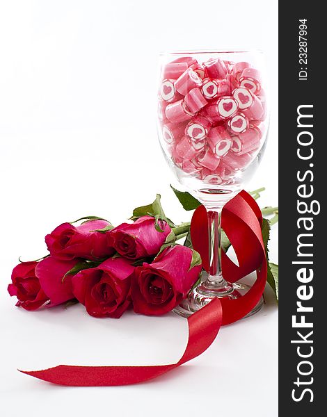 Valentine Series, Candy in wine glass with rose on white background