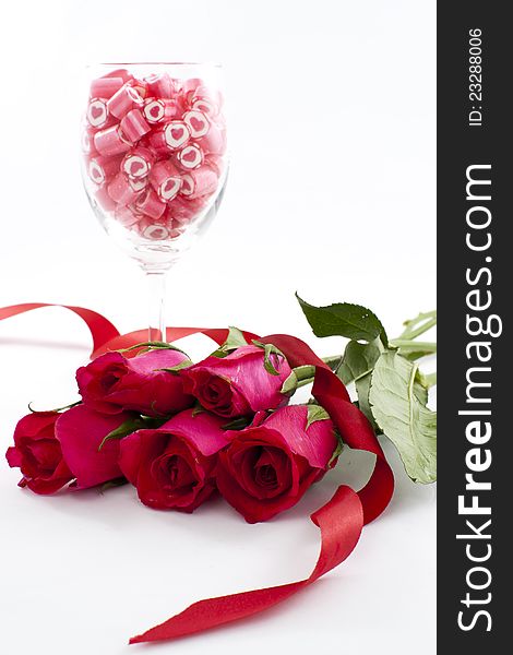 Valentine Series, Candy in wine glass with rose on white background