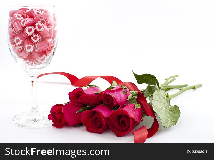 Valentine Series, Candy in wine glass with rose on white background