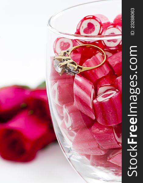 Diamond Ring And Candy In Wine Glass