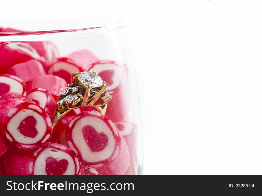 Valentine Series, Diamond Ring and Candy in wine glass on white background