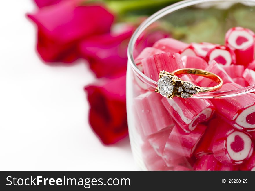 Valentine Series, Diamond Ring and Candy in wine glass on white background
