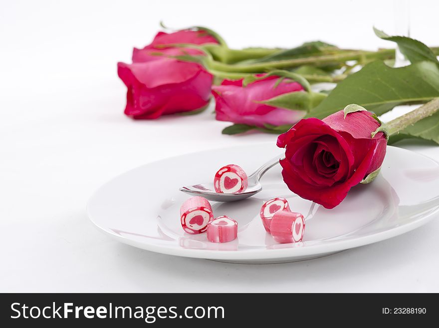 Valentine Series, Candy on dish with rose on white background