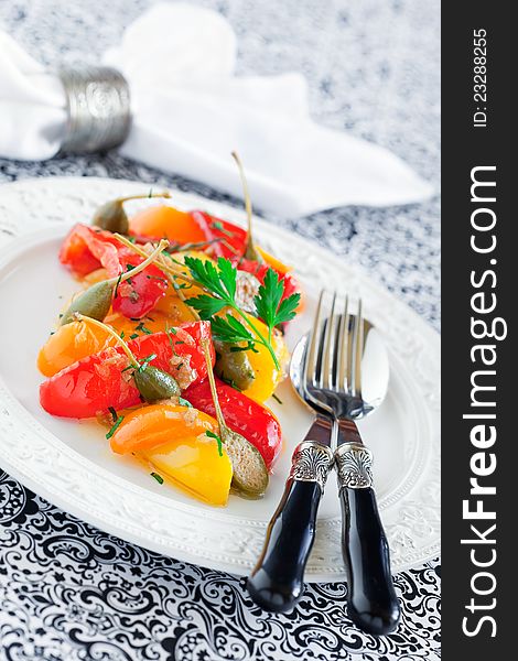 Italian stewed peppers with capers and anchovies, selective focus. Italian stewed peppers with capers and anchovies, selective focus