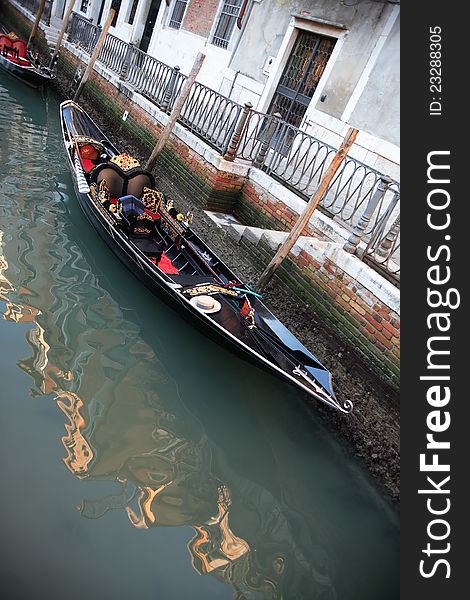 Urban scene in Venice, Italy. Empty gondola near dwelling house on a canal. Urban scene in Venice, Italy. Empty gondola near dwelling house on a canal