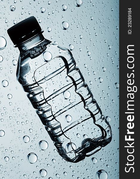 Bottle of clear purified water against abstract backgrounds