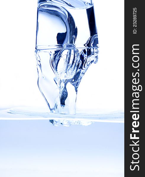 Water splashing from glass isolated on white