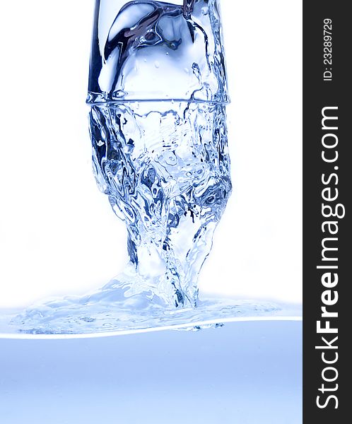 Water splashing from glass isolated on white