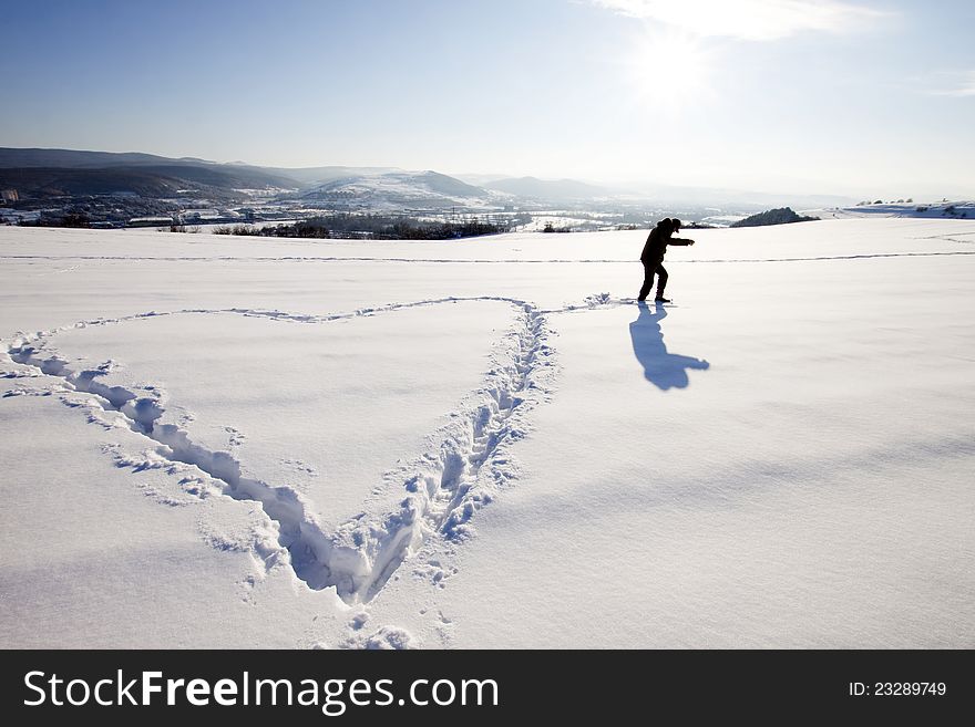 Man making big heart sign in snow