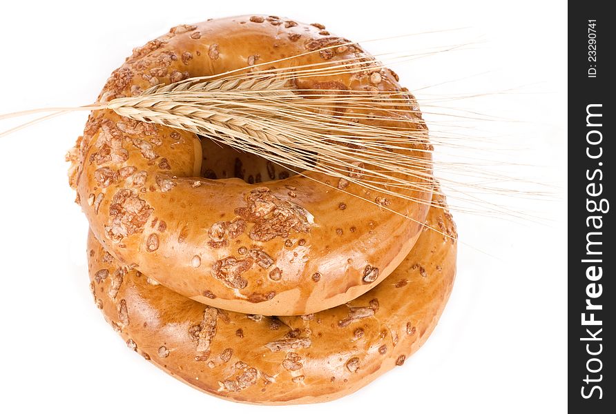 Bagels with wheat ears on white