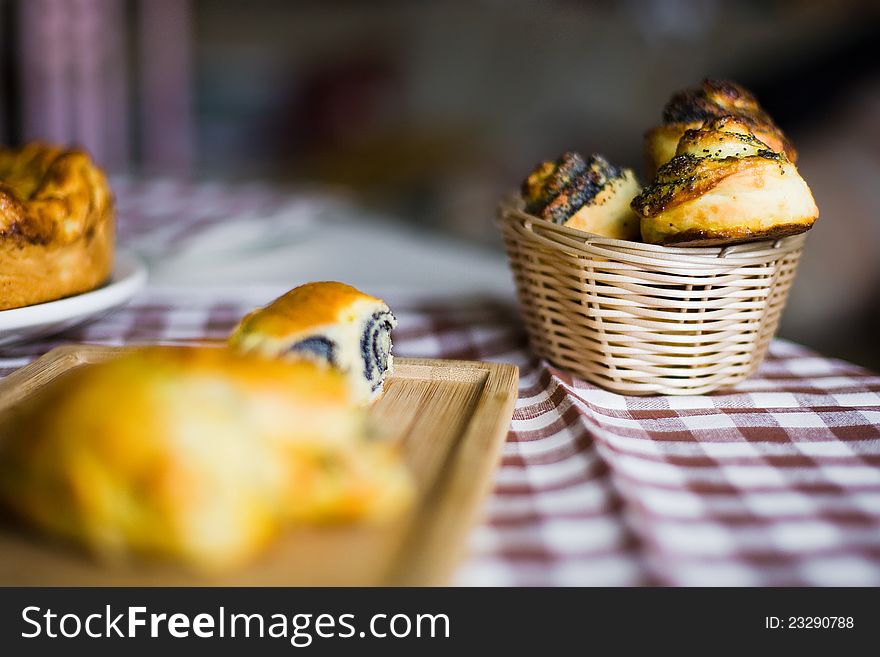 Bun with poppy seeds in a basket. Bun with poppy seeds in a basket