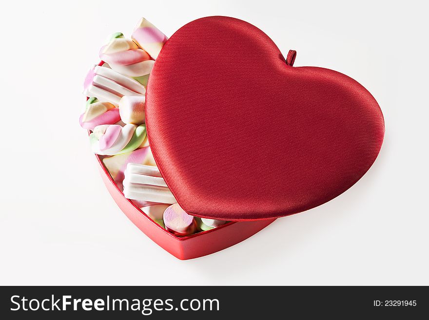 Red heart box full of marshmallow on white background