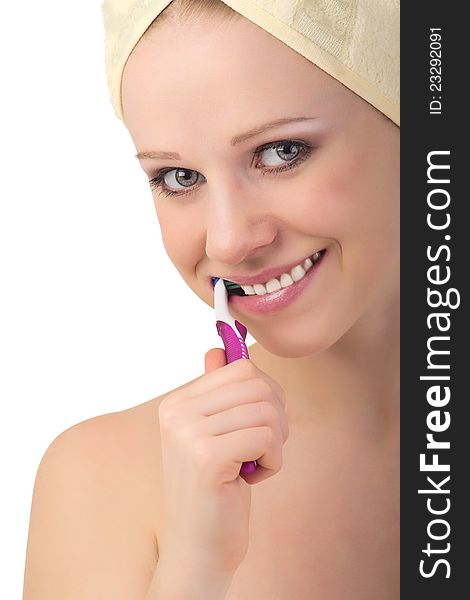 Healthy  girl in a towel cleans teeth with a toothbrush isolated on white background. Healthy  girl in a towel cleans teeth with a toothbrush isolated on white background