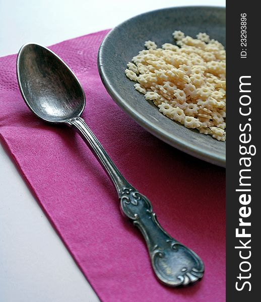 Old retro spoon with plate and pasta, creative food concept