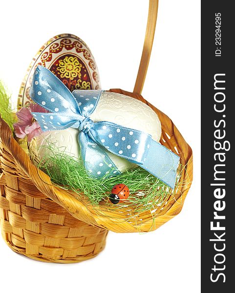 Easter Eggs   in the basket on a white basket