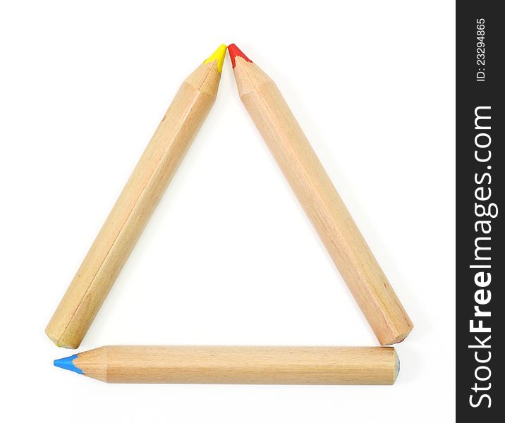 Colored Pencils set as a triangle frame on white