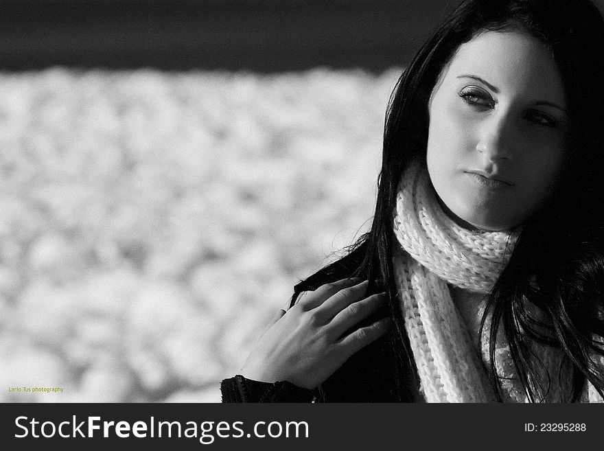 Young woman outdoor portrait on blue airy background in black and white technique