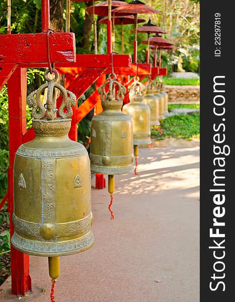 Big metal bells with red umbrella in Thai temple. Big metal bells with red umbrella in Thai temple