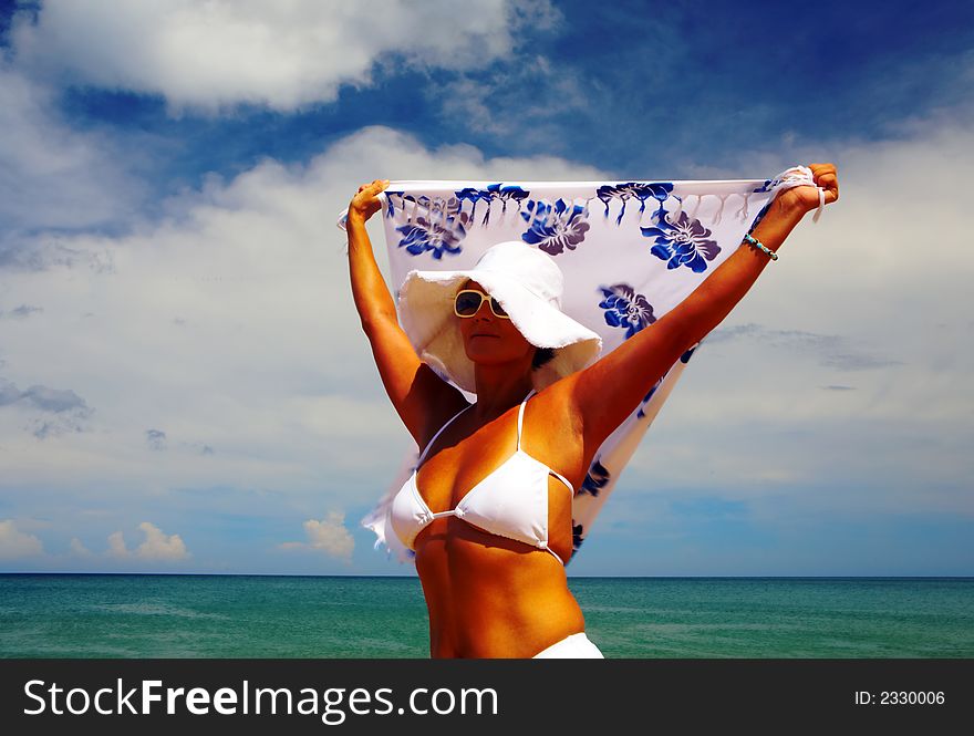 View of nice woman in white panama and bikini on tropical beach. View of nice woman in white panama and bikini on tropical beach