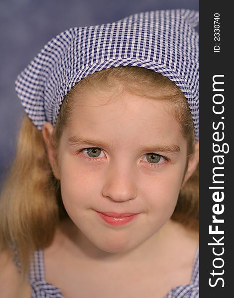Shot of a cute little girl portrait on blue vertical