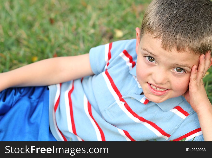 Shot of a little boy in the grass