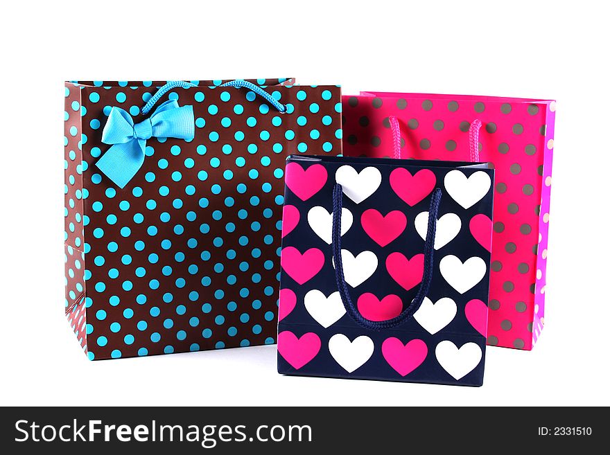 Three bright gift bags isolated on white. Three bright gift bags isolated on white