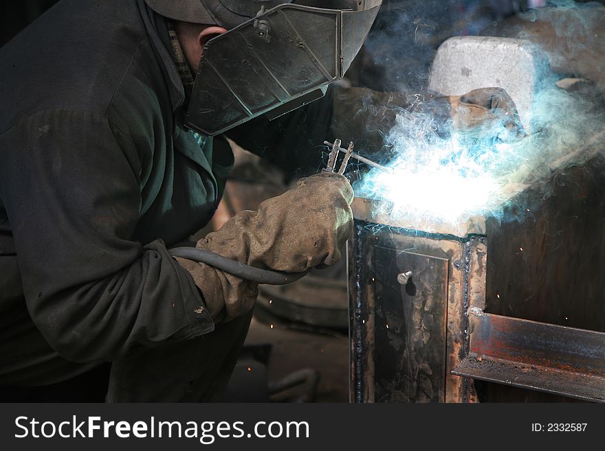 The welder behind work at a modern factory