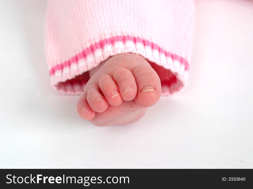 Close up of child's toes on a white background