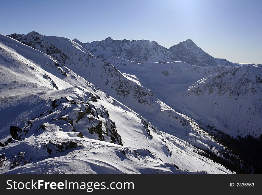 High mountain covered with snow in sunny winter day