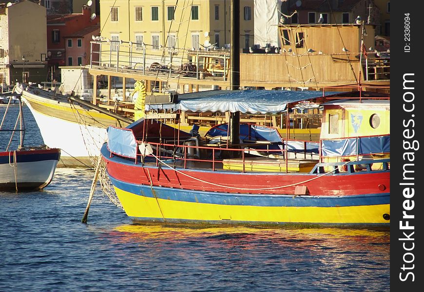 Colorful fishing and excursion boats in the harbor of seaside town Rovinj in Istria, Croatia, Europe . Colorful fishing and excursion boats in the harbor of seaside town Rovinj in Istria, Croatia, Europe