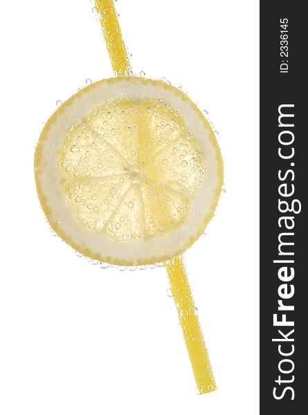 Slice of lemon, plastic straw in mineral water