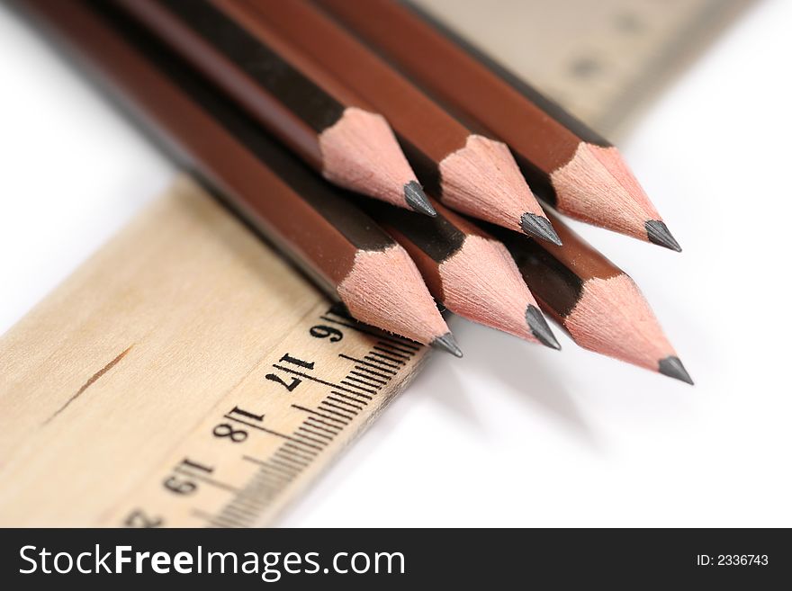 Sharp pencils and ruler on white background