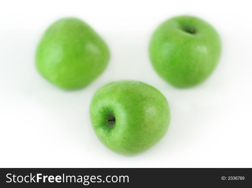 Three fresh green apples on white background