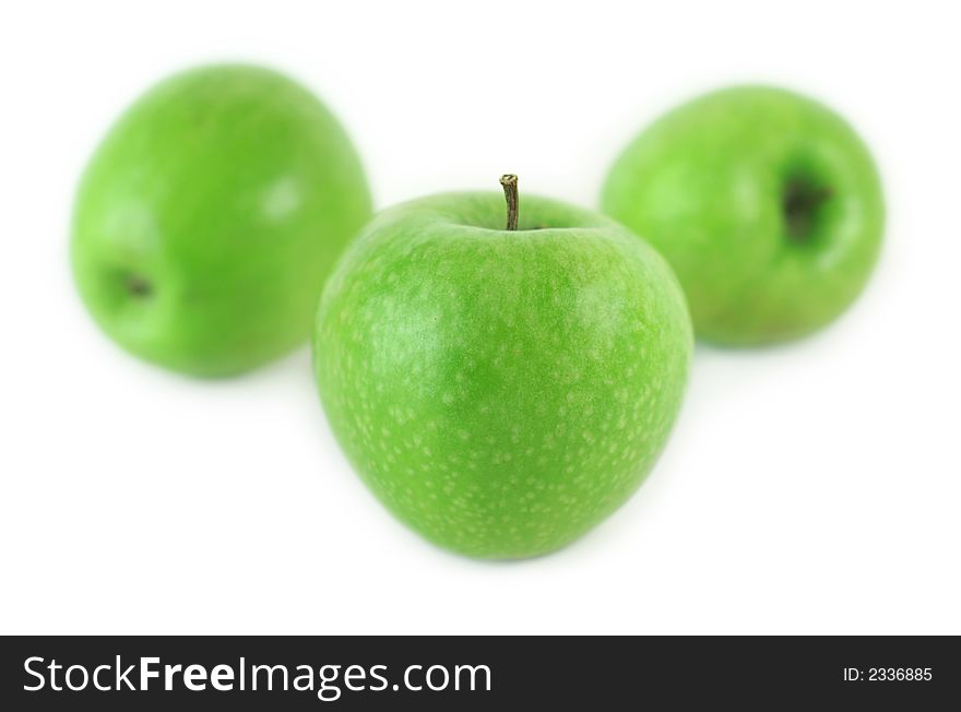 Three juicy green apples on white background