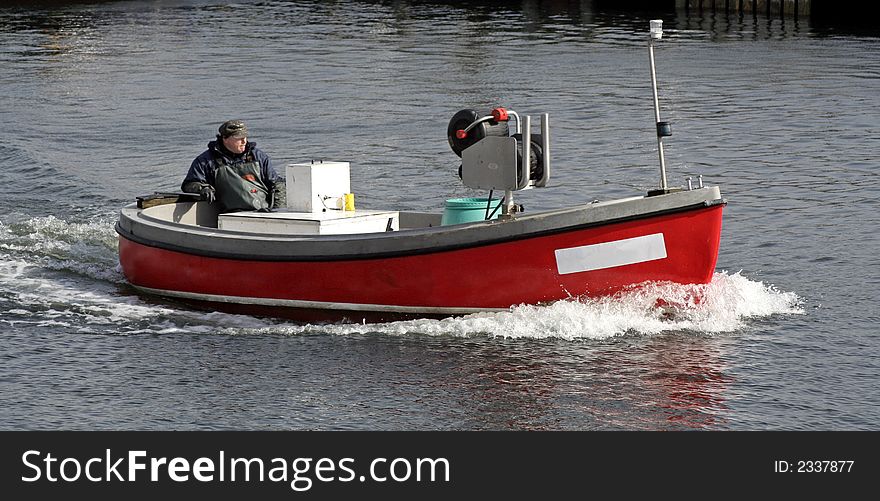 Fisherman in a motor boat at sea