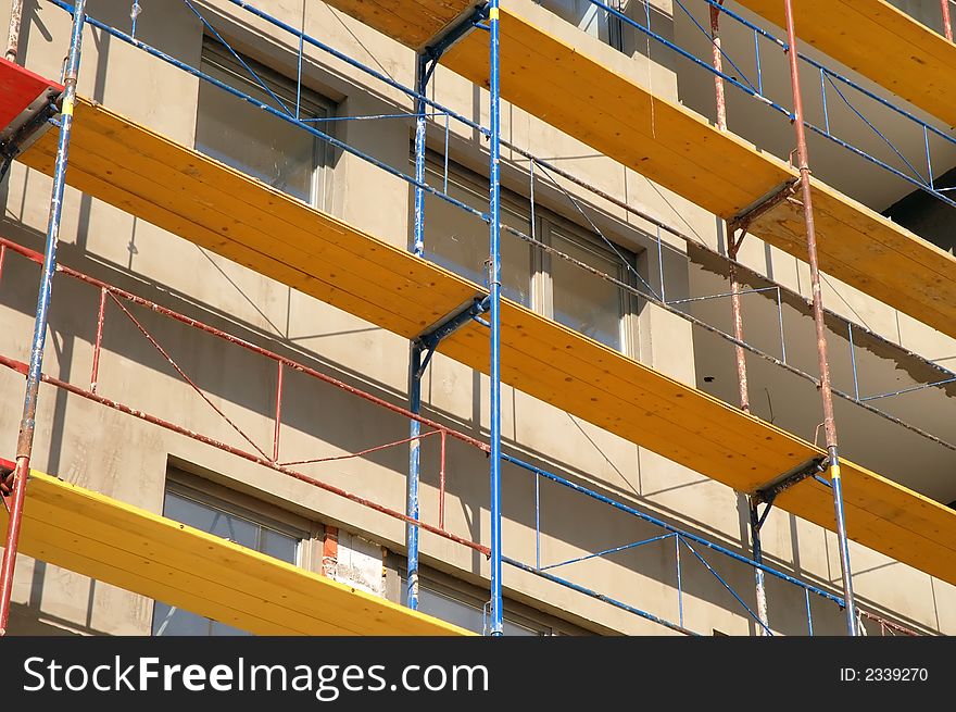Scaffold of various colors on construction site
