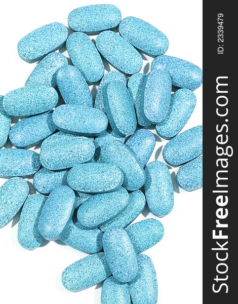 Group of blue pills with a shallow depth of focus