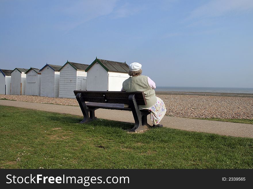 Lady taking a rest on seafront bench. Lady taking a rest on seafront bench