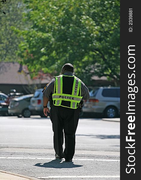 A local county police officer directing traffic