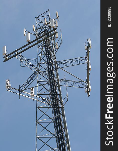 A Cell phone tower against a blue sky. A Cell phone tower against a blue sky