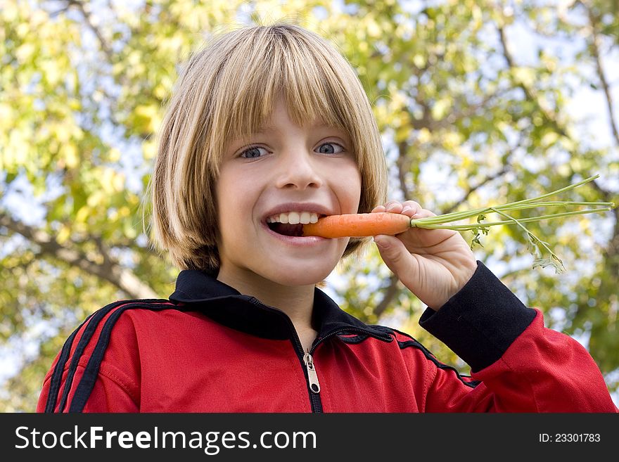 Young Boy Eating A Carrot