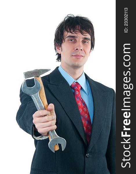 Elegant smiling businessman handing out hammer and wrench isolated on white.