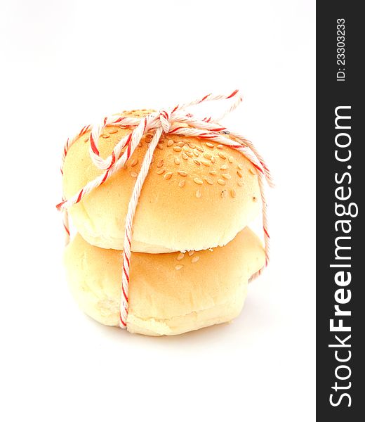 Delicious buns with sesame seeds on white background