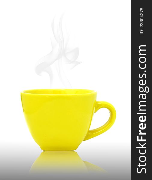 Yellow cup with hot drink on reflect floor and white background