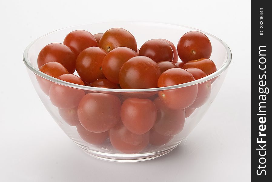 A lot of tomatoes cherry in the glass bowl