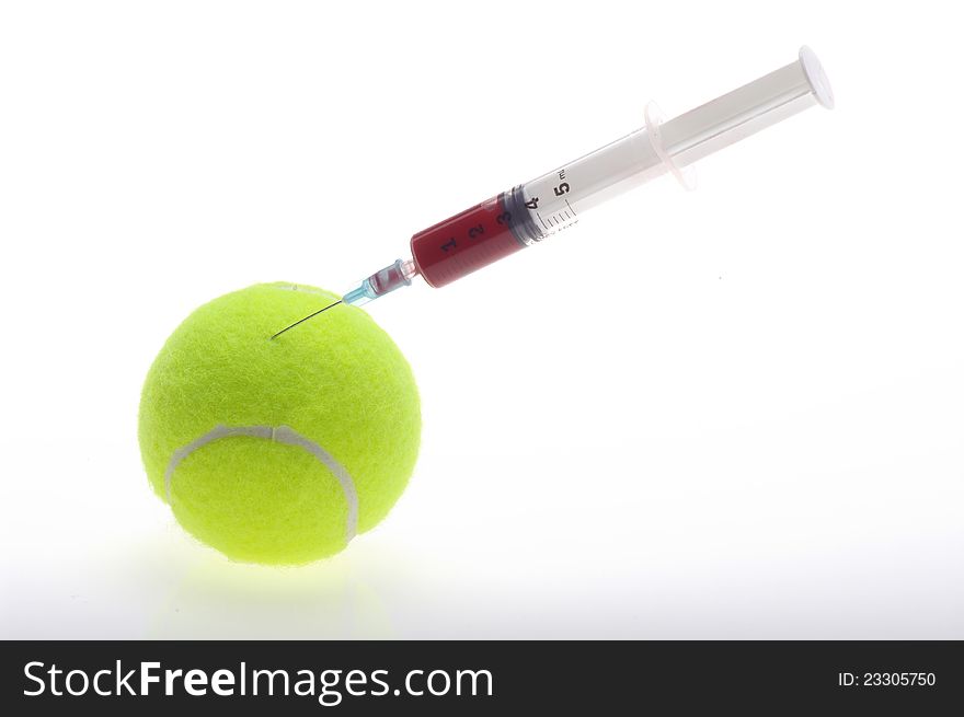 Tennis ball with a syringe on white background. Tennis ball with a syringe on white background