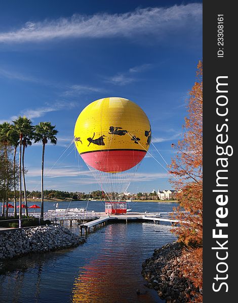 Multicolored balloon moored to landing stage at lake