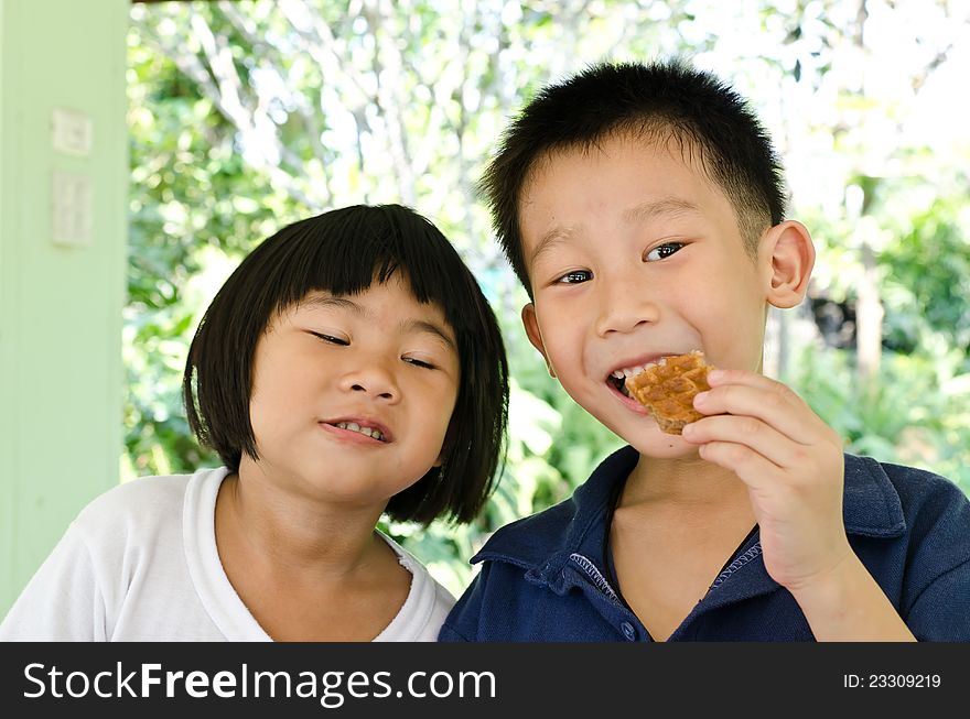 Happy brother and sister enjoy muffin