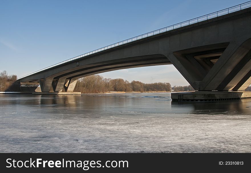 Bridge crossing the river with ice