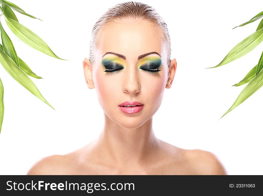 Beautiful blonde with artistic make- up and  bamboo leaves. Beautiful blonde with artistic make- up and  bamboo leaves